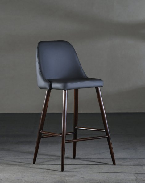 A closeup of an armless chair with a concave back, loft-style furniture