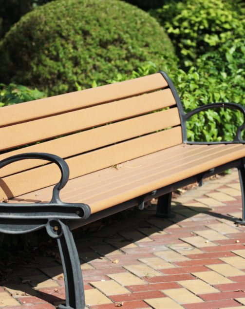 Park bench in the sunshine at a park