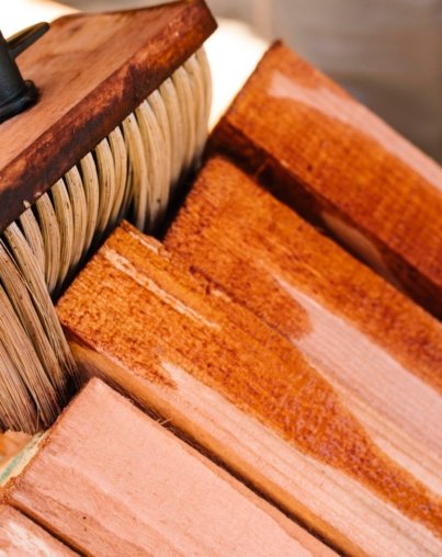 person-varnishing-wood-with-big-brush